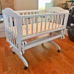 white wooden bassinet